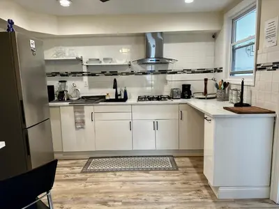 a kitchen with white cabinets and a stove at 3-A Diamond in Yonkers, NY in Yonkers