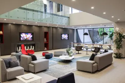 a lobby with couches and chairs and a tv at Chelsea 1BR w Balcony Doorman Gym NYC-135 in New York