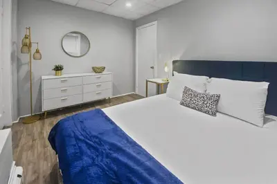 a bedroom with a large bed with a blue blanket at Stylish & Cozy Perfect Hub for Stamford Escapades in Stamford
