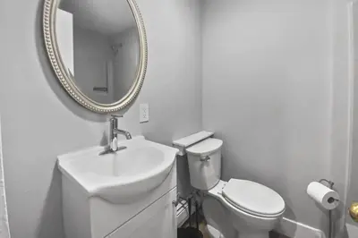 a white bathroom with a sink and a mirror at Stylish & Cozy Perfect Hub for Stamford Escapades in Stamford