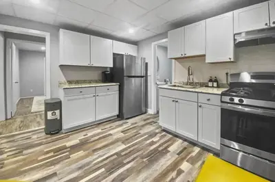 a kitchen with white cabinets and stainless steel appliances at Stylish & Cozy Perfect Hub for Stamford Escapades in Stamford