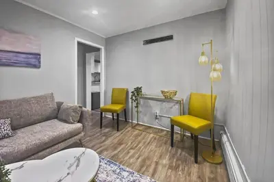 a living room with a couch and two chairs at Stylish & Cozy Perfect Hub for Stamford Escapades in Stamford