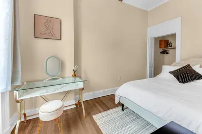 a bedroom with a bed and a desk with a mirror at Charming 2Bd in Brooklyn Heights in Brooklyn