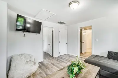 a living room with a couch and a tv on a wall at Cozy Glens Falls Getaway Less Than 1 Mi to Downtown in Glens Falls
