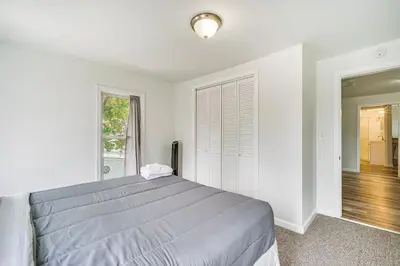a white bedroom with a bed and a window at Cozy Glens Falls Getaway Less Than 1 Mi to Downtown in Glens Falls