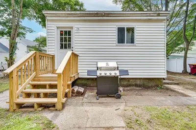 a tiny house with a staircase and a stove at Cozy Glens Falls Getaway Less Than 1 Mi to Downtown in Glens Falls