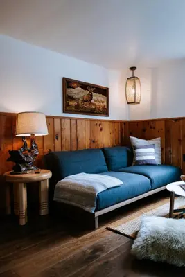a living room with a blue couch and a table at The Leeway in Mount Tremper