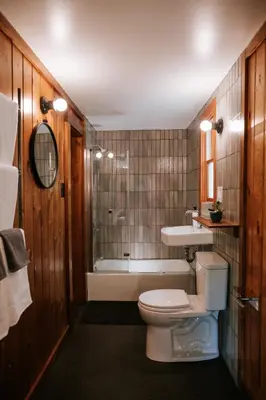 a bathroom with a toilet and a sink and a tub at The Leeway in Mount Tremper