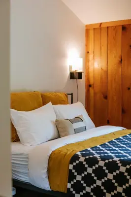 a bedroom with a large bed with white pillows at The Leeway in Mount Tremper