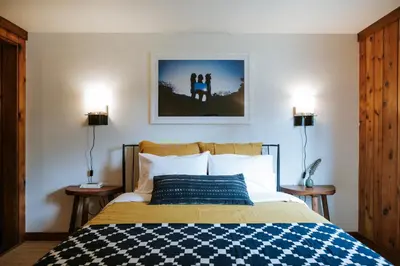 a bedroom with a bed with a blue and white comforter at The Leeway in Mount Tremper