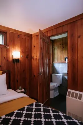 a bedroom with a bed and a bathroom with a toilet at The Leeway in Mount Tremper