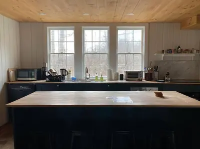 a kitchen with a large island in the middle at Mountain Farmhouse (The Lorca, Catskills) in Shandaken