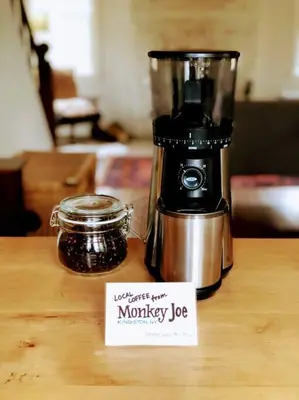 a coffee maker sitting on a wooden table with a sign at Mountain Farmhouse (The Lorca, Catskills) in Shandaken