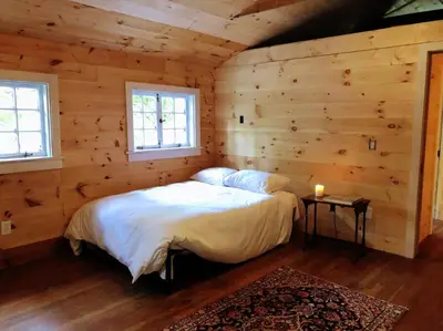 a bedroom with a bed in a log cabin at Mountain Farmhouse (The Lorca, Catskills) in Shandaken
