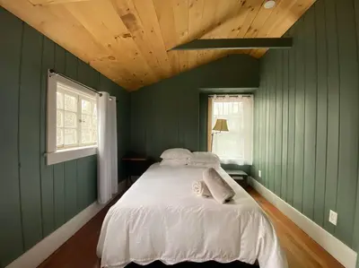 a bedroom with green walls and a large bed at Mountain Farmhouse (The Lorca, Catskills) in Shandaken