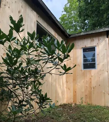 a building with a window and a tree next to it at Stream House (The Lorca, Catskills) in Shandaken