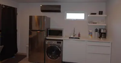 a kitchen with a stainless steel refrigerator and a microwave at Silva Domus in West Orange