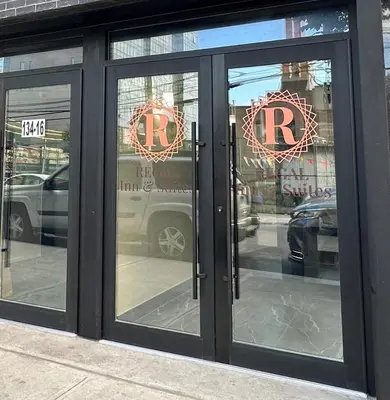 a store front with glass doors with the wordsrt on them at Regal Inn & Suites New York LaGuardia Hotel in Flushing