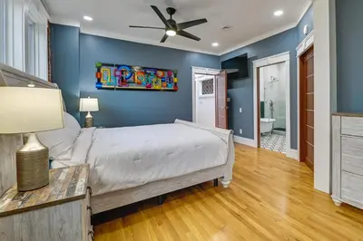 a bedroom with a bed and a ceiling fan at Contemporary Cohoes Retreat with Electric Fireplace! in Cohoes
