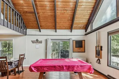 a dining room with a table with a red cover on it at Poconos Chalet newly renovated, great location home in Tobyhanna