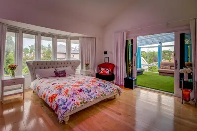 a bedroom with a bed with a colorful bedspread at GABLES new 2024 in Bayside