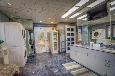 a large bathroom with a sink and a refrigerator at GABLES new 2024 in Bayside