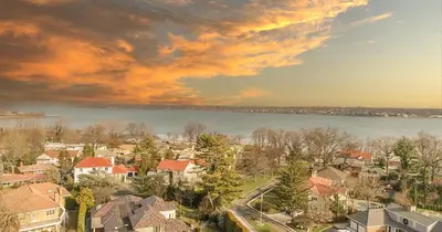 an aerial view of a town with houses and a lake at GABLES new 2024 in Bayside