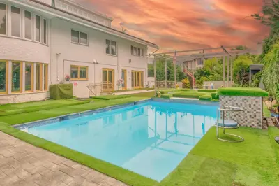 a swimming pool in the yard of a house at GABLES new 2024 in Bayside