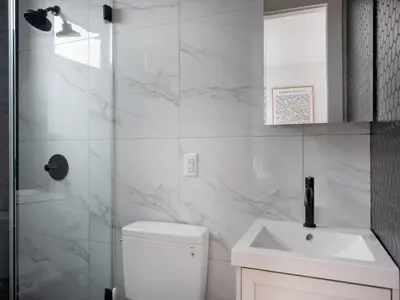 a bathroom with a toilet and a sink and a shower at Three Bedroom Brooklynite Suite! in Brooklyn