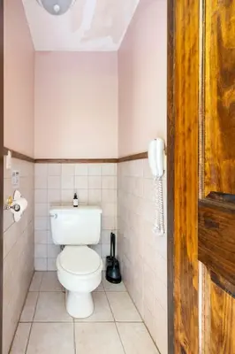 a bathroom with a toilet and a phone at Bethel Woods Retreat - wPool, Hot Tub & Arcade! in Mongaup Valley