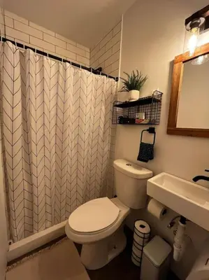 a bathroom with a white toilet and a sink at Bethel Woods Cabin in Mongaup Valley