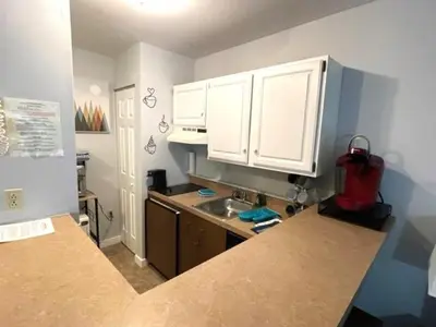 a kitchen with white cabinets and a counter top at Mountain View Suite on Jiminy Peak Ski On Off -New in Hancock