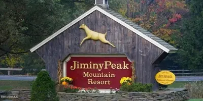a sign for a mountain resort with a dog on top at Mountain View Suite on Jiminy Peak Ski On Off -New in Hancock