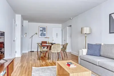 a living room with a couch and a table at Midtown E 1BR w Gym Doorman nr the 6 NYC-4 in New York