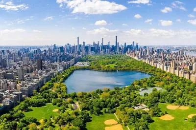 an aerial view of a city with a lake at SWJ 2nd - Times SQ, Brooklyn Bridge, LGA in 15 min in New York