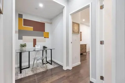 a dining room with a table and a hallway at SWJ 3rd - Sleeps 7,Close to LGA,Times Sq in 25 min in New York