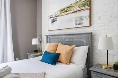a bedroom with a white bed with pillows and two lamps at SWJ 3rd - Sleeps 7,Close to LGA,Times Sq in 25 min in New York