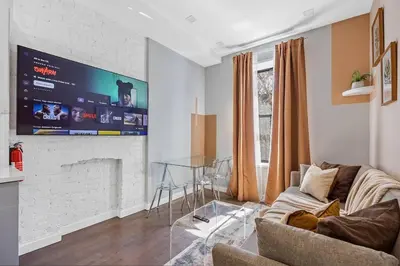 a living room with a couch and a fireplace at SWJ 3rd - Sleeps 7,Close to LGA,Times Sq in 25 min in New York