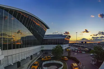 a large building with cars parked in a parking lot at SWJ 5th - Perfect for Tourism: Near Train, Times Sq, Dining in New York