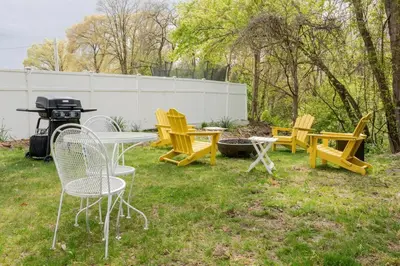 a group of chairs and a table and a grill at Double The Fun II Two Houses and fire pit in shared yard in Kingston