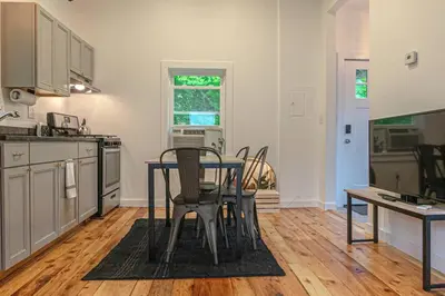 a kitchen with a table and chairs in it at Double The Fun II Two Houses and fire pit in shared yard in Kingston