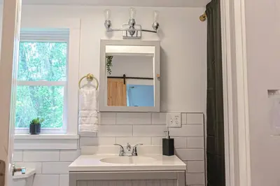 a bathroom with a sink and a mirror and a window at Double The Fun II Two Houses and fire pit in shared yard in Kingston