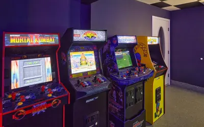three arcade video game machines in a room at Luxuriously Restored Farm Cabin in Mountainhome