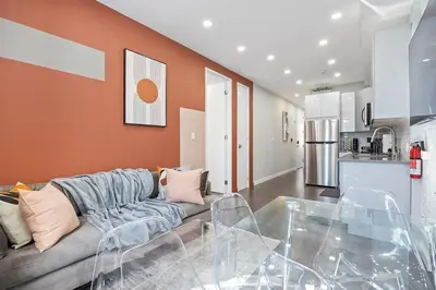 a living room with a couch and a kitchen at SWJ 4th and 5th - Save on 2Day+ Stays_Duplex in New York