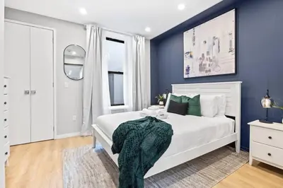 a bedroom with a white bed and blue walls at SWJ Btm G, 1 and 2 - Save on 2Day+ Stays_6Br Triplex in New York