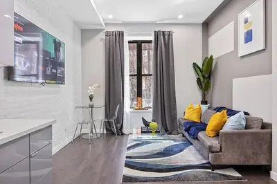a living room with a couch and a kitchen at SWJ Btm G, 1 and 2 - Save on 2Day+ Stays_6Br Triplex in New York