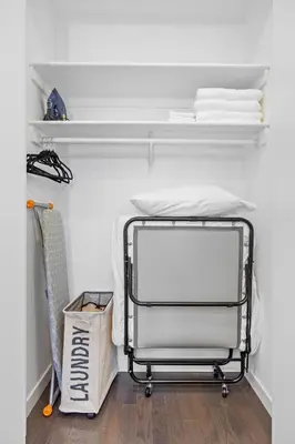 a white room with a bed and a cart at SWJ Whole Bldg - Largest Place in NYC_21 Beds_6 apts in New York