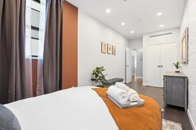 a bedroom with a white bed and a window at SWJ Whole Bldg - Largest Place in NYC_21 Beds_6 apts in New York