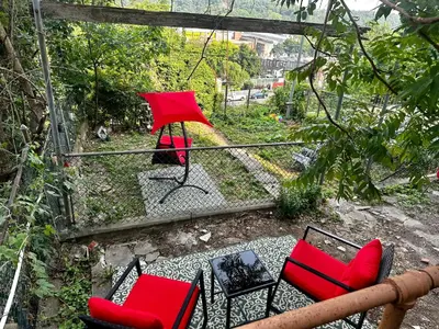 a patio with red chairs and an umbrella at 8-A Diamond in Yonkers, NY in Yonkers