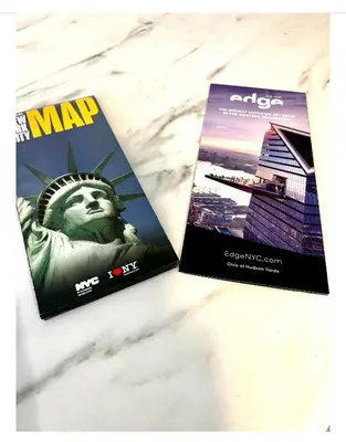 two magazines sitting on a table with the statue of liberty at 8-A Diamond in Yonkers, NY in Yonkers